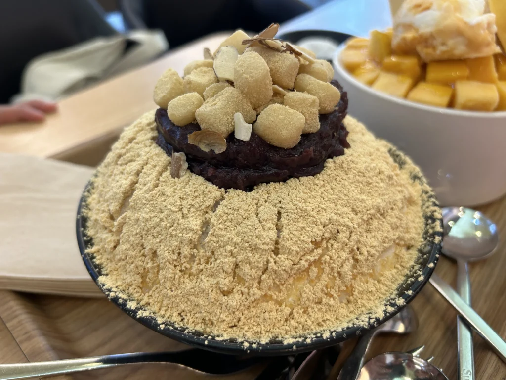 Korean Shaved Ice: Sulbing injeolmi (toasted rice cake crumble) shaved ice piled high with condensed milk and red bean