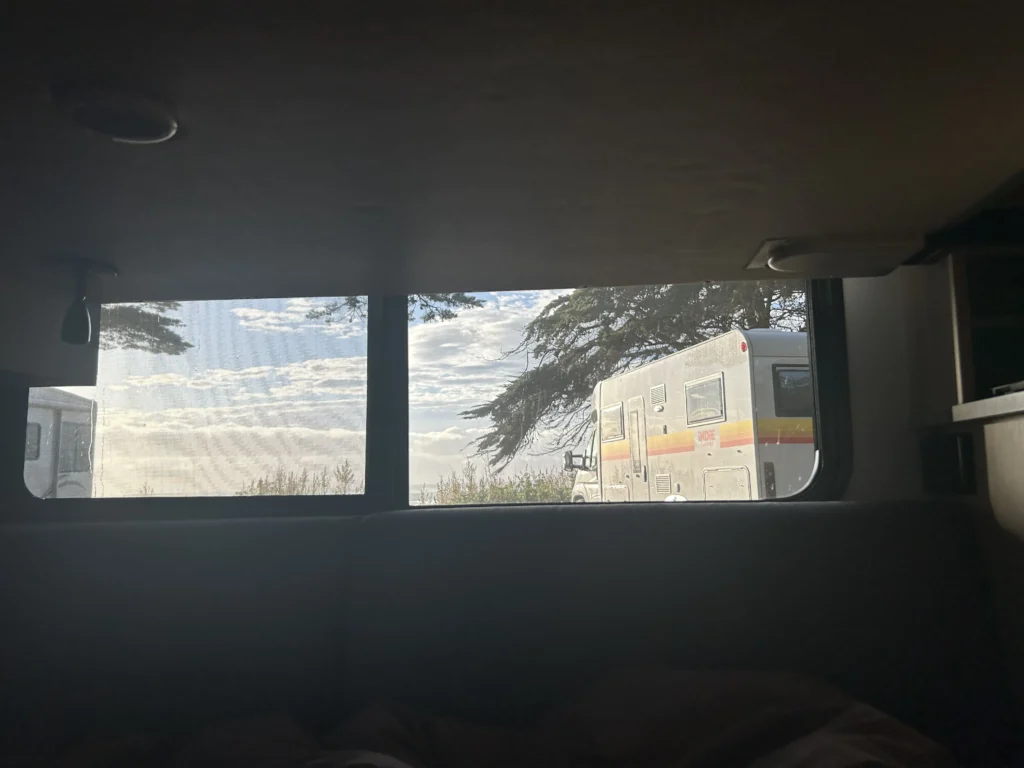 Katiki Beach North Reserve a beachfront spot. The ocean was right there — not "five minutes walk away", not "nearby". Right there. You open the campervan door and you're looking at the sea.