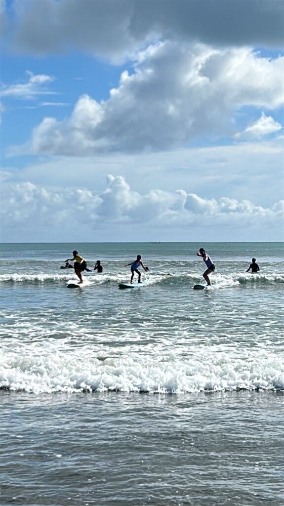 Family surfing in Bali Kuta