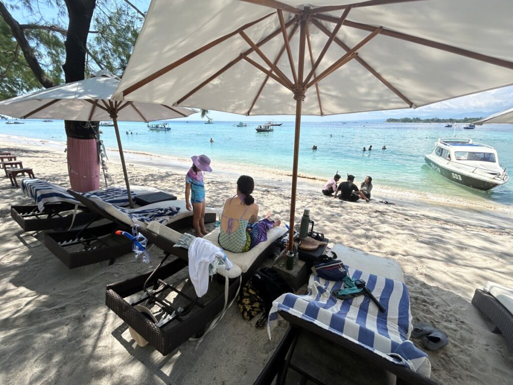 a family silhouette against a beautiful Gili Trawangan beach backdrop)