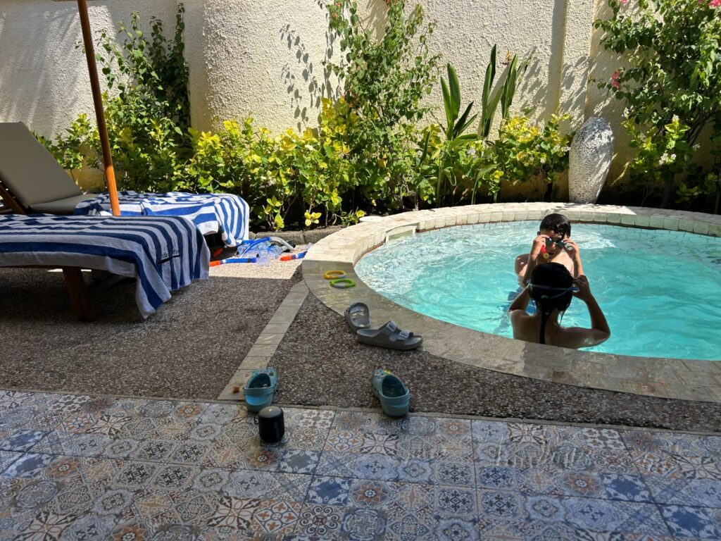 Kids happily splashing in the small pool)