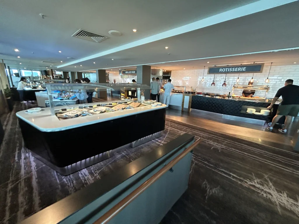 Stratosfare buffet stations at Queenstown Skyline Luge — Grilled Fare and Rotisserie counters with diners serving themselves